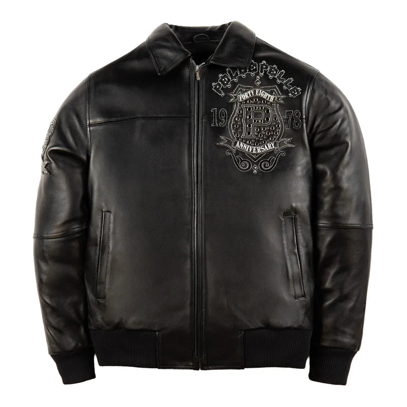 Front view of the Pelle Pelle Unrivaled Anniversary black jacket featuring a detailed chest crest, anniversary graphics, and front zipper