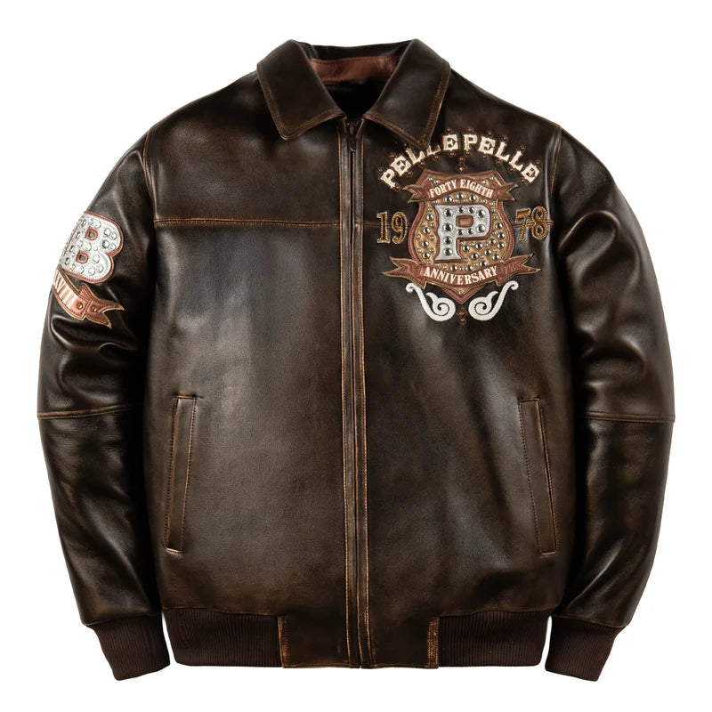 Front view of the Pelle Pelle Unrivaled Anniversary brown jacket with decorative P chest crest, anniversary lettering, and full-length zipper