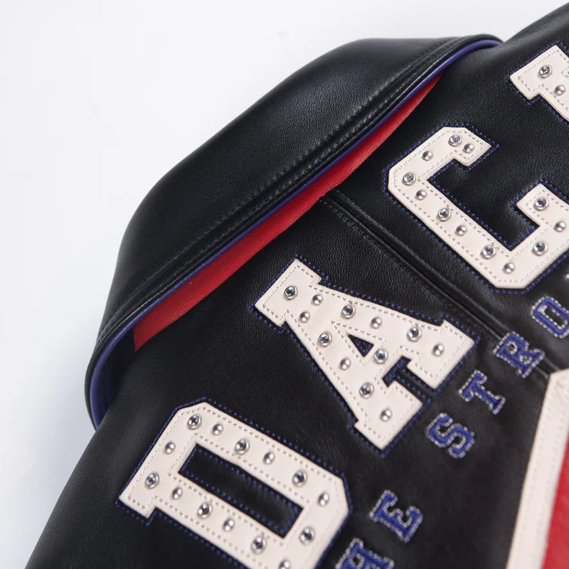  Close-up of the Pelle Pelle jacket's studded lettering and contrasting decorative graphic panels.