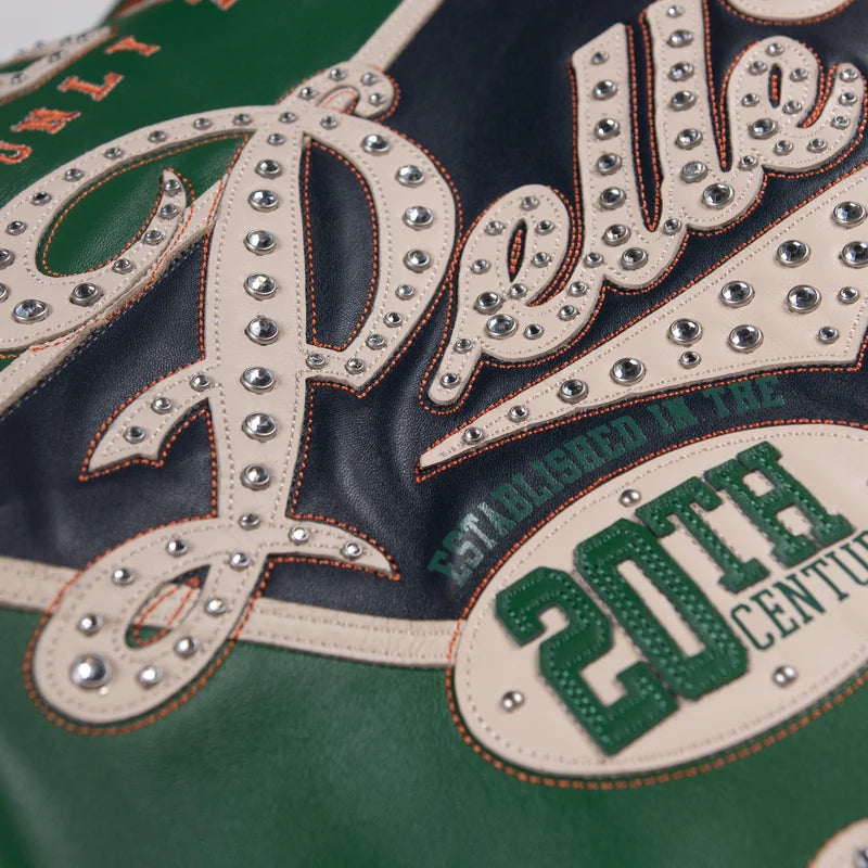 Close-up of the green Pelle Pelle jacket's studded lettering and layered Soda Club 78 graphic details.