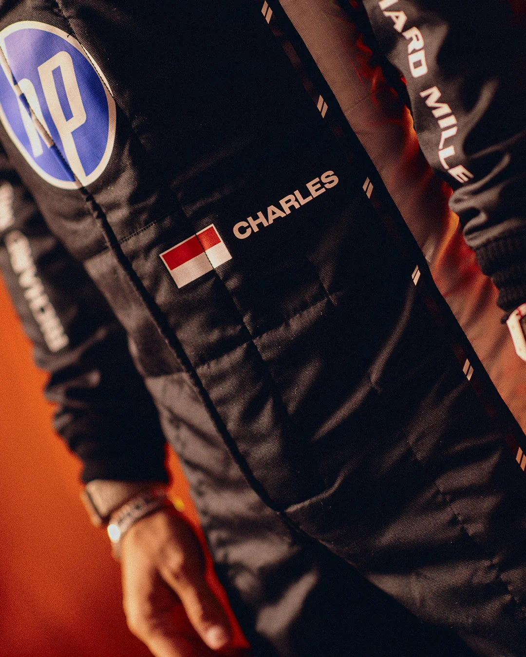 Close up of black 2026 F1 racing suit driver detailing
