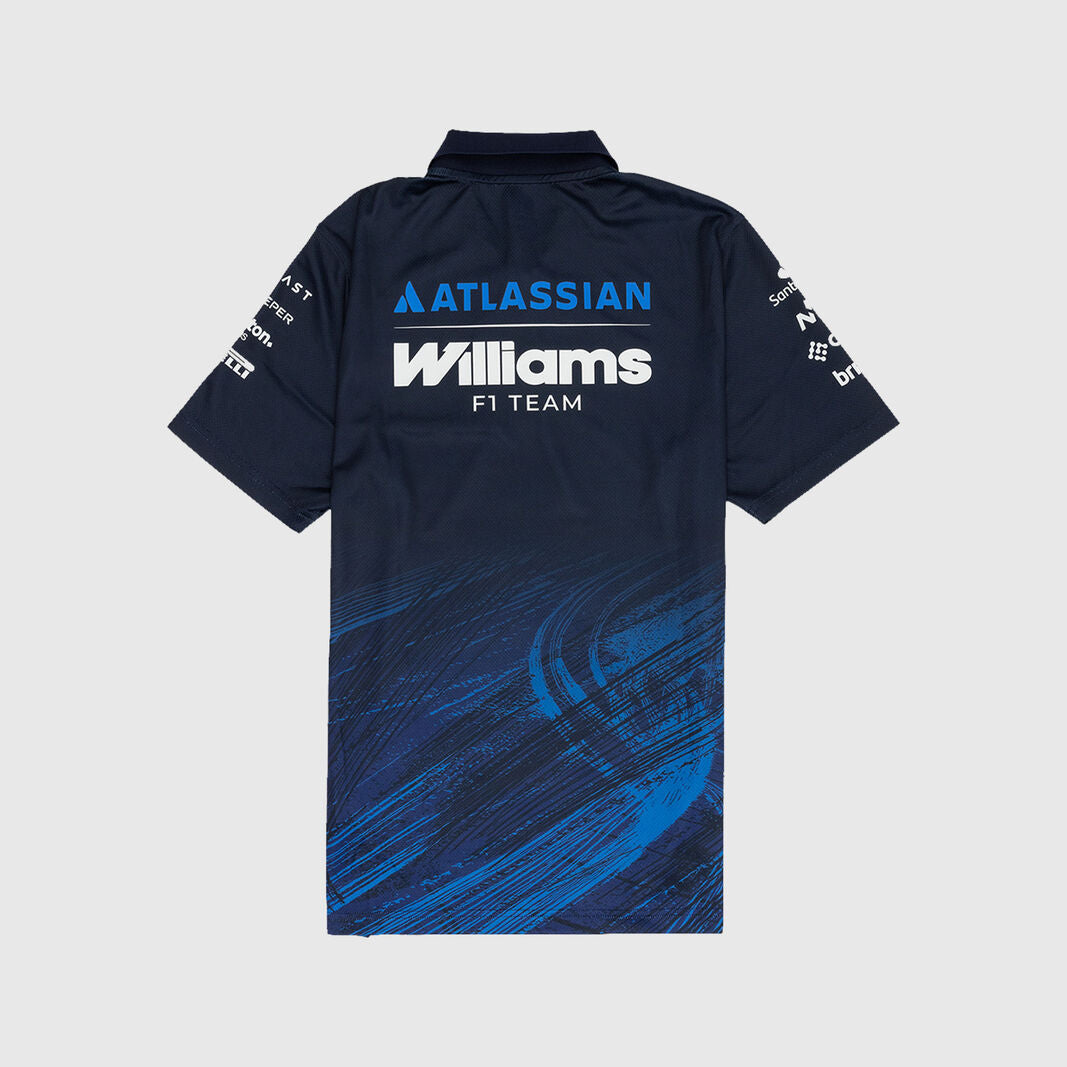 A short-sleeve polo shirt shown from the back, featuring a dark navy base with a blue and black tire-track graphic pattern across the lower half. The back is printed with 'ATLASSIAN Williams F1 TEAM' in white and blue, and the sleeves feature sponsor logos.