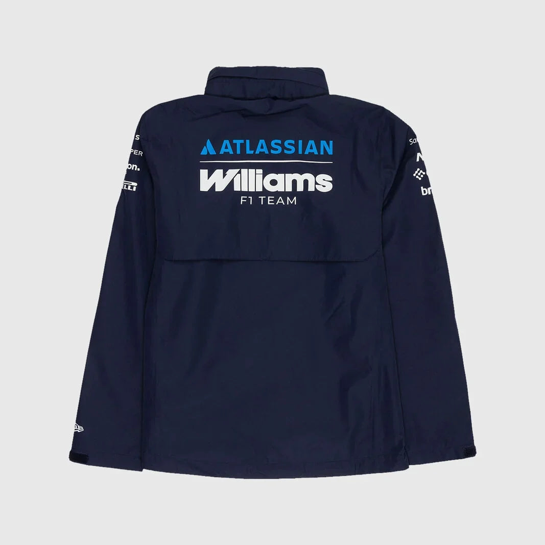 A navy blue long-sleeve jacket shown from the back, featuring 'ATLASSIAN Williams F1 TEAM' printed in white and blue on the upper back, with sponsor logos on the sleeves, set against a light gray background.