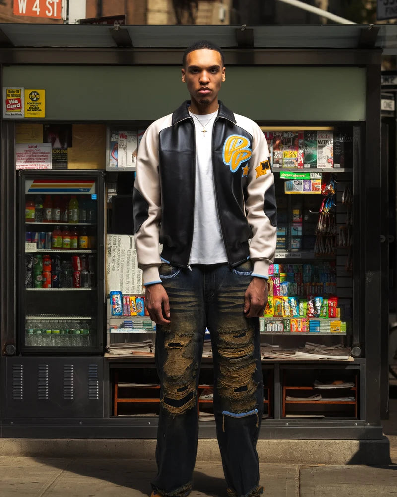 Model wearing a black and cream Pelle Pelle Classic Soda Club Jacket with yellow and light-blue PP chest graphics