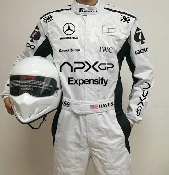 A person wearing a white racing suit with black side panels and multiple sponsor logos, holding a white racing helmet. Visible branding on the suit includes Mercedes, OMP, IWC, GEIC, Shark NINJA, and APXGP.
