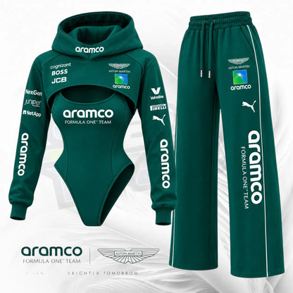A dark green Formula One team tracksuit set featuring a hooded bodysuit and matching sweatpants, both decorated with white 'aramco' branding, sponsor logos, and Aston Martin wing emblems, shown on a light gray background.