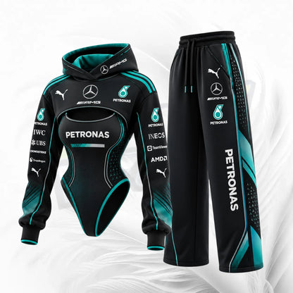 A two-piece racing tracksuit set featuring a black hooded sweatshirt and matching pants with teal and white Petronas / Mercedes / Puma sponsor graphics, shown on a light gray abstract background.